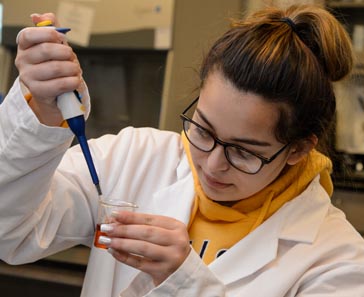 Student pipetting.